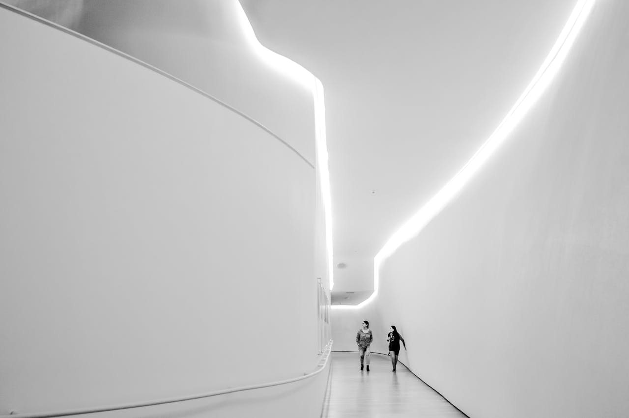 Futuristic indoor hallway in black and white with two people walking, CDMX, Mexico.